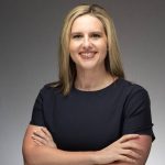 Caroline Ryals of the New York Junior League smiles at the camera in a professional headshot.