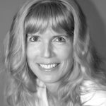 Jephtha Tausig of the New York Junior League smiles at the camera in a professional headshot.