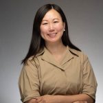 Kyunhea West of the New York Junior League smiles at the camera in a professional headshot.