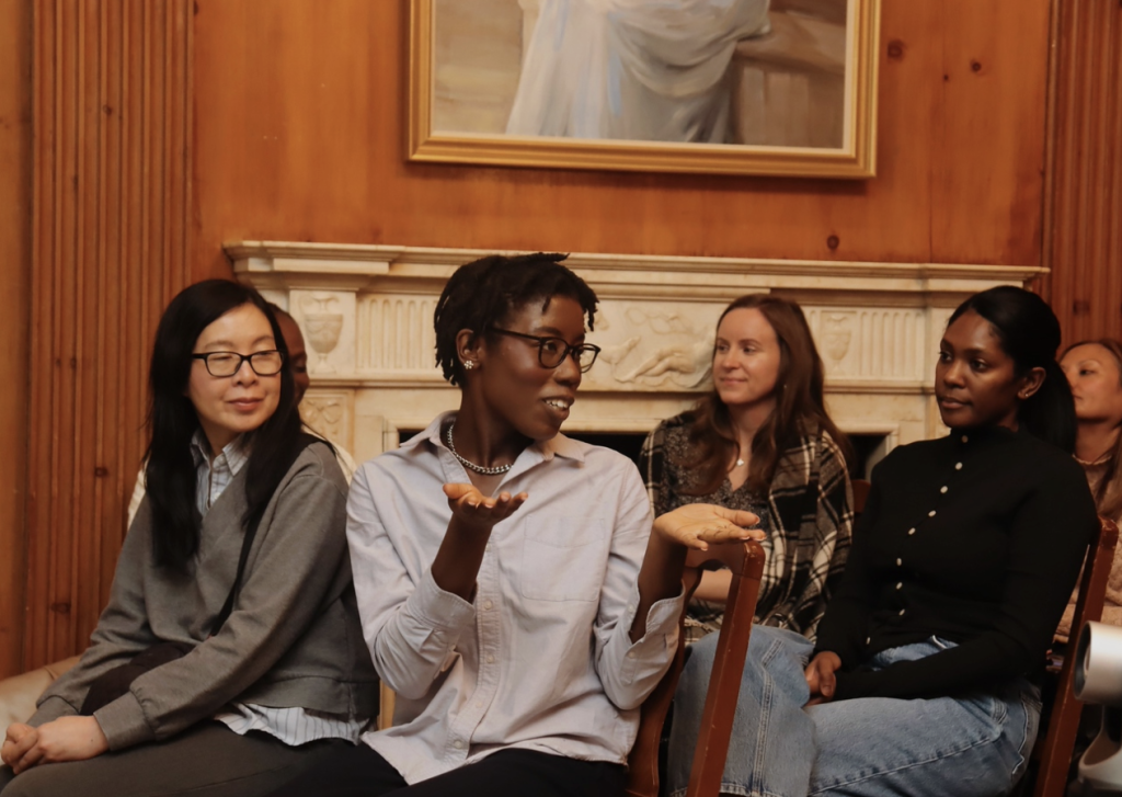 A NYJL member sits among the crowd, answering questions during a training session.
