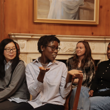 A NYJL member sits among the crowd, answering questions during a training session.